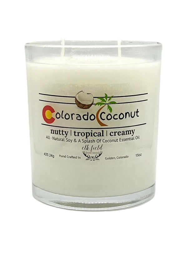 a white candle in a glass container