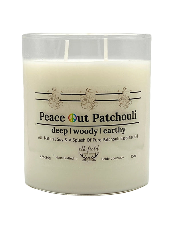 a white candle in a glass container Patchouli